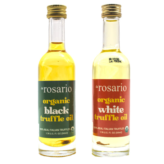 Two glass bottles, one labeled as 'daRosario organic black truffle oil' and the other as 'daRosario organic white truffle oil'. Both have gold-colored caps and are marked with USDA organic labels.