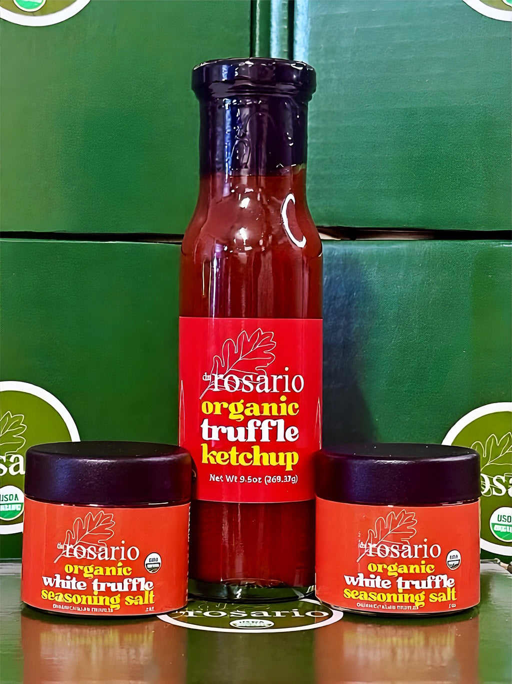 Rosario organic truffle ketchup and white truffle seasoning salt bottles on a green background