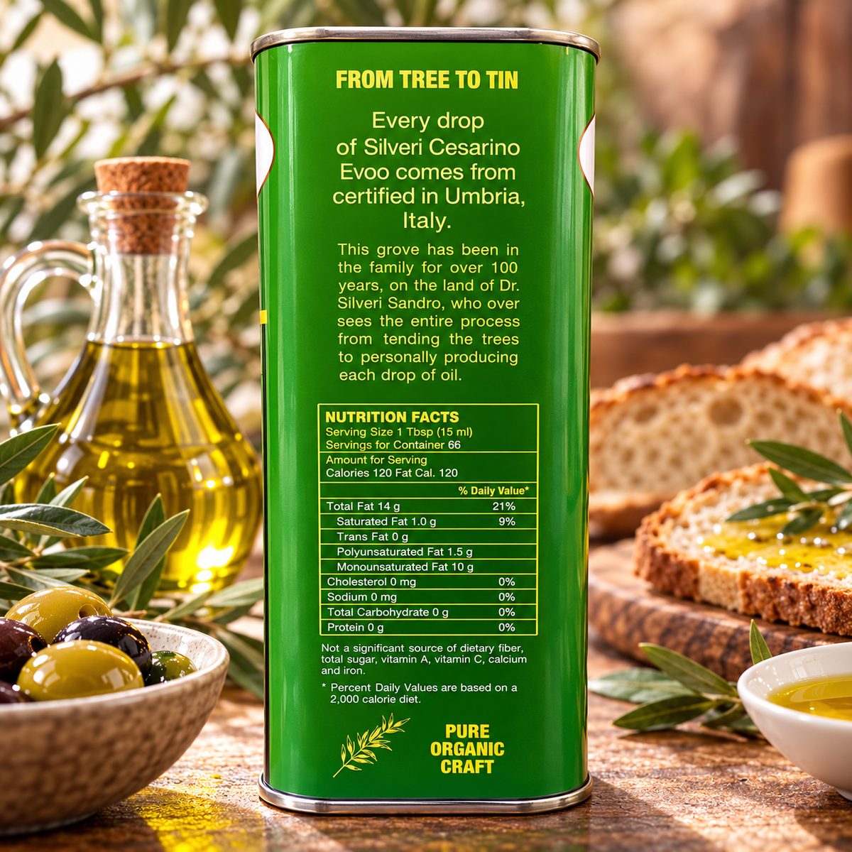 A tall green canister of Silveri Cesaro Evo olive oil stands on a rustic wooden table, with the back label clearly visible. Surrounding it are a glass bottle of olive oil, a bowl of whole and sliced olives, and a slice of bread on a wooden board.